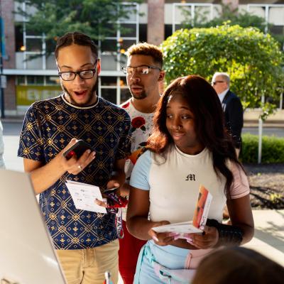 Kevane and friends looking at the materials passed out for the event